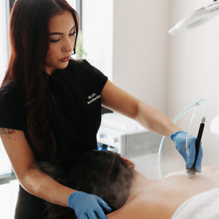 Diamond Glow body treatment device exfoliating and hydrating the skin of the back