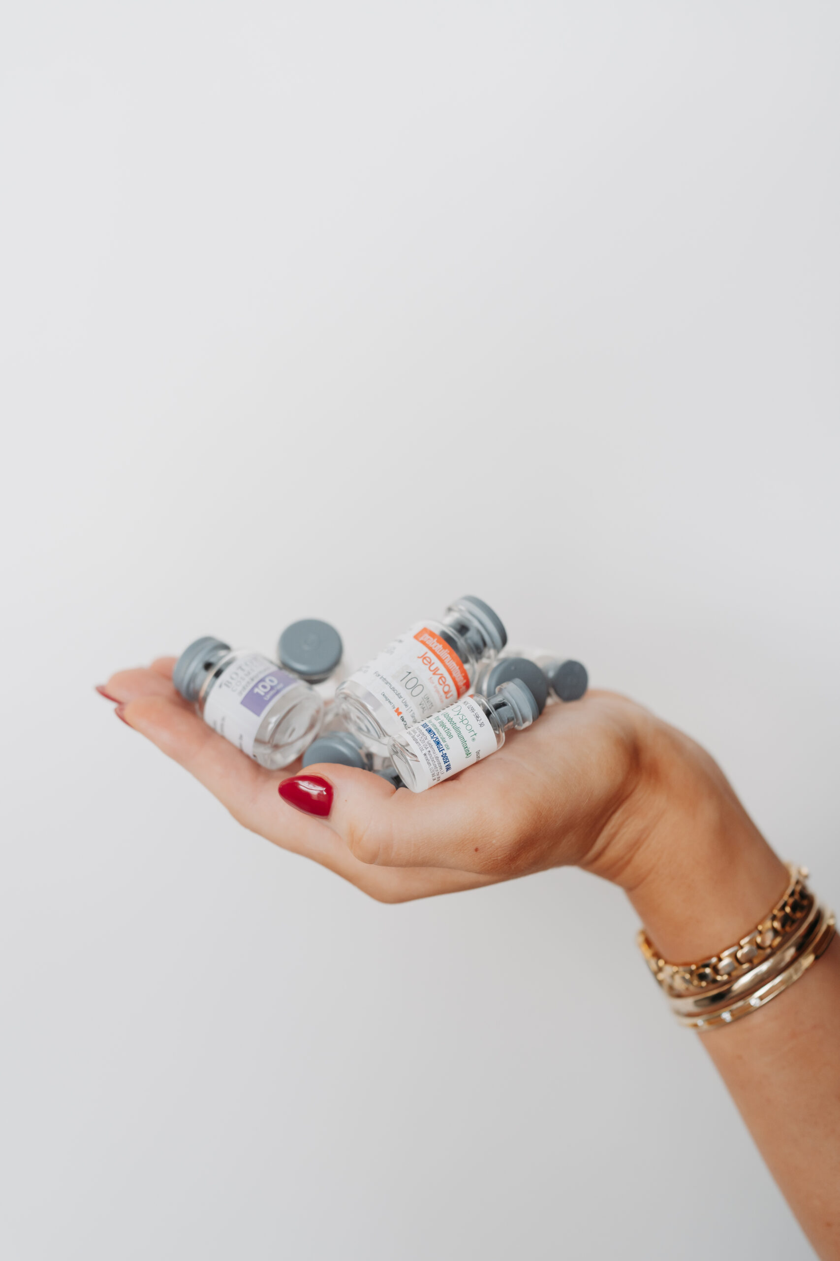 Hand holding vials of Botox